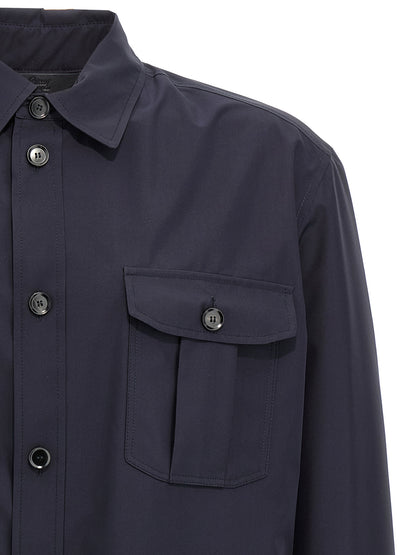 Jacket by Brioni for men in silk blue features an utilitarian silhouette with a refined wrap shirt-collar neckline, showcasing sophisticated pockets for an utilitarian aesthetic.