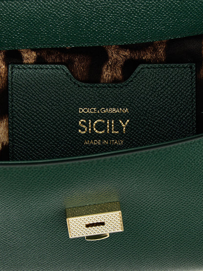 This Flap Handbag by Dolce & Gabbana for women in calfskin leather and bicolour & green presents a sculptural silhouette featuring a secure snap & flap, ample , and versatile shoulder-strap, adjustable-strap & handle for a sculptural finish.
