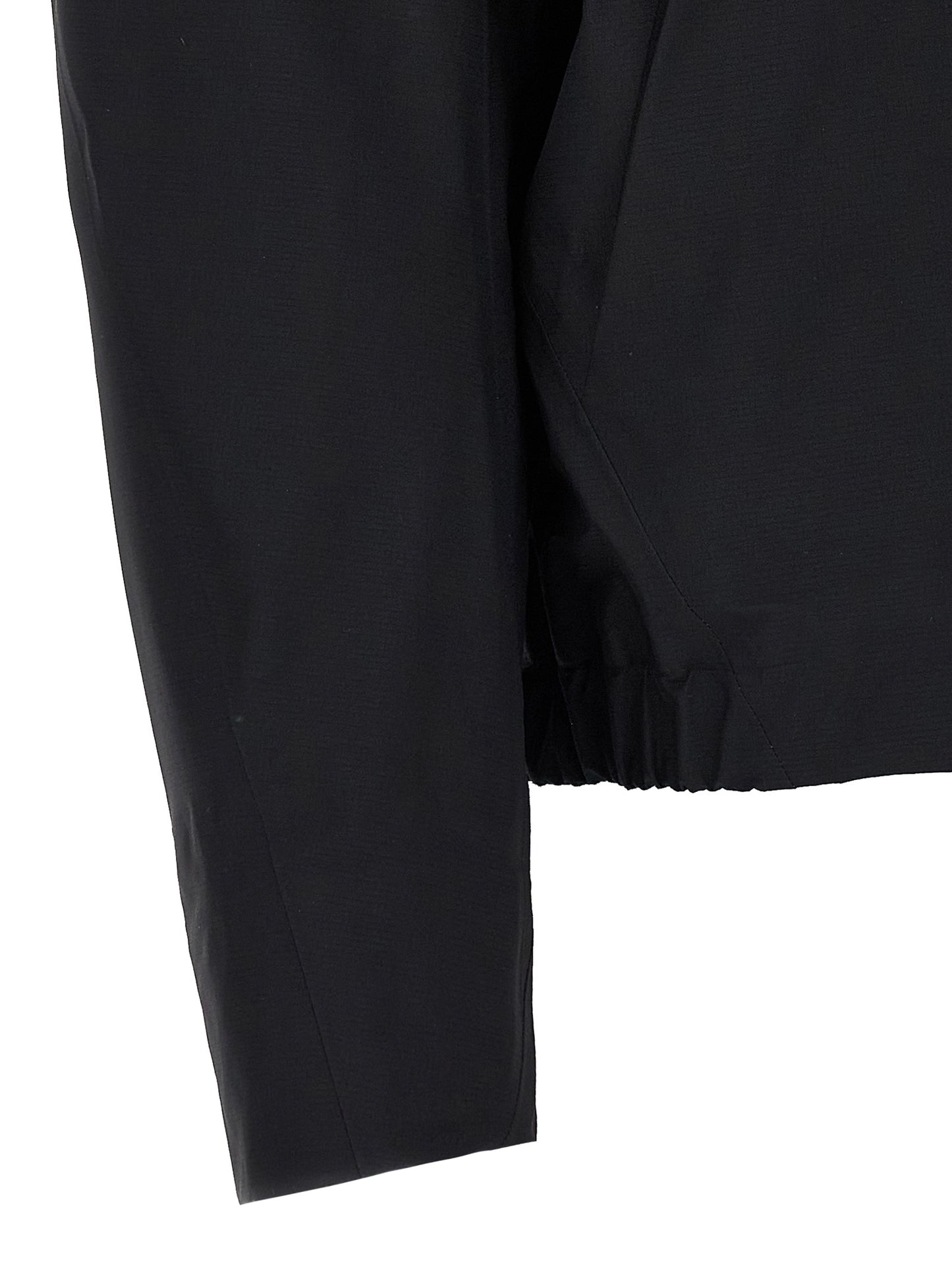 Hooded Windbreaker Jacket by Arc'teryx Veilance for women in nylon & silicone black features an perennial silhouette with a refined and perennial water-resistant, windproof, lightweight, pockets & hooded for a sophisticated weather-resistant look.