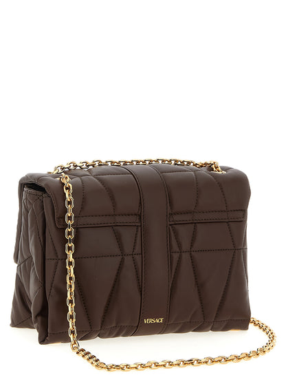 Quilted Shoulder Flap Bag by Versace for women in lamb leather brown features a effortless chic silhouette with a secure flap & magnetic, ample , and versatile shoulder-strap for a effortless chic finish.
