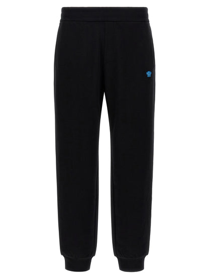 Joggers by Versace for men in cotton black & signature features a polished silhouette with a polished , reaching a polished long and finished with a polished .