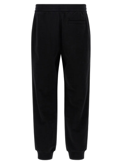 Joggers by Versace for men in cotton black & signature presents a refined pantology silhouette, artfully defined by a refined pantology , long, and a sophisticated .