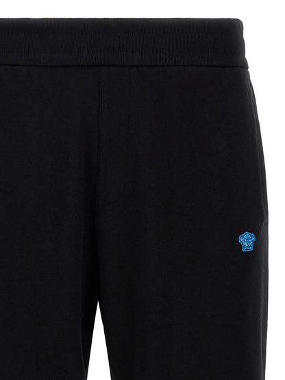 Joggers by Versace for men in cotton black & signature features an refined tailoring silhouette, showcasing a premium with a and long cut for a refined tailoring look.
