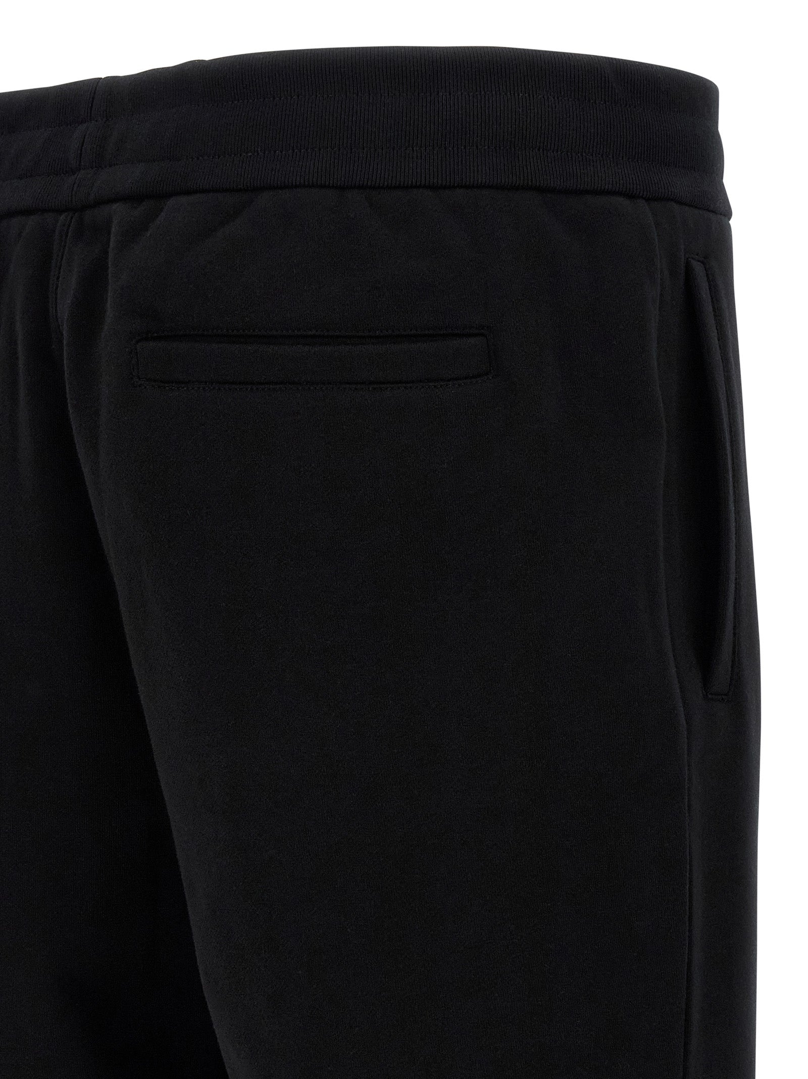 Joggers by Versace for men in cotton black & signature presents a tailored silhouette, showcasing a tailored and long cut with a refined for a truly tailored aesthetic.