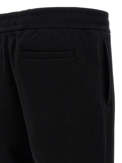 Joggers by Versace for men in cotton black & signature presents a tailored silhouette, showcasing a tailored and long cut with a refined for a truly tailored aesthetic.