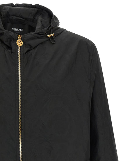 Hooded Windbreaker Jacket by Versace for men in nylon black, patterned & jacquard showcases a urban chic silhouette, detailed with a urban chic hooded neckline and functional hooded & windproof for a polished finish.
