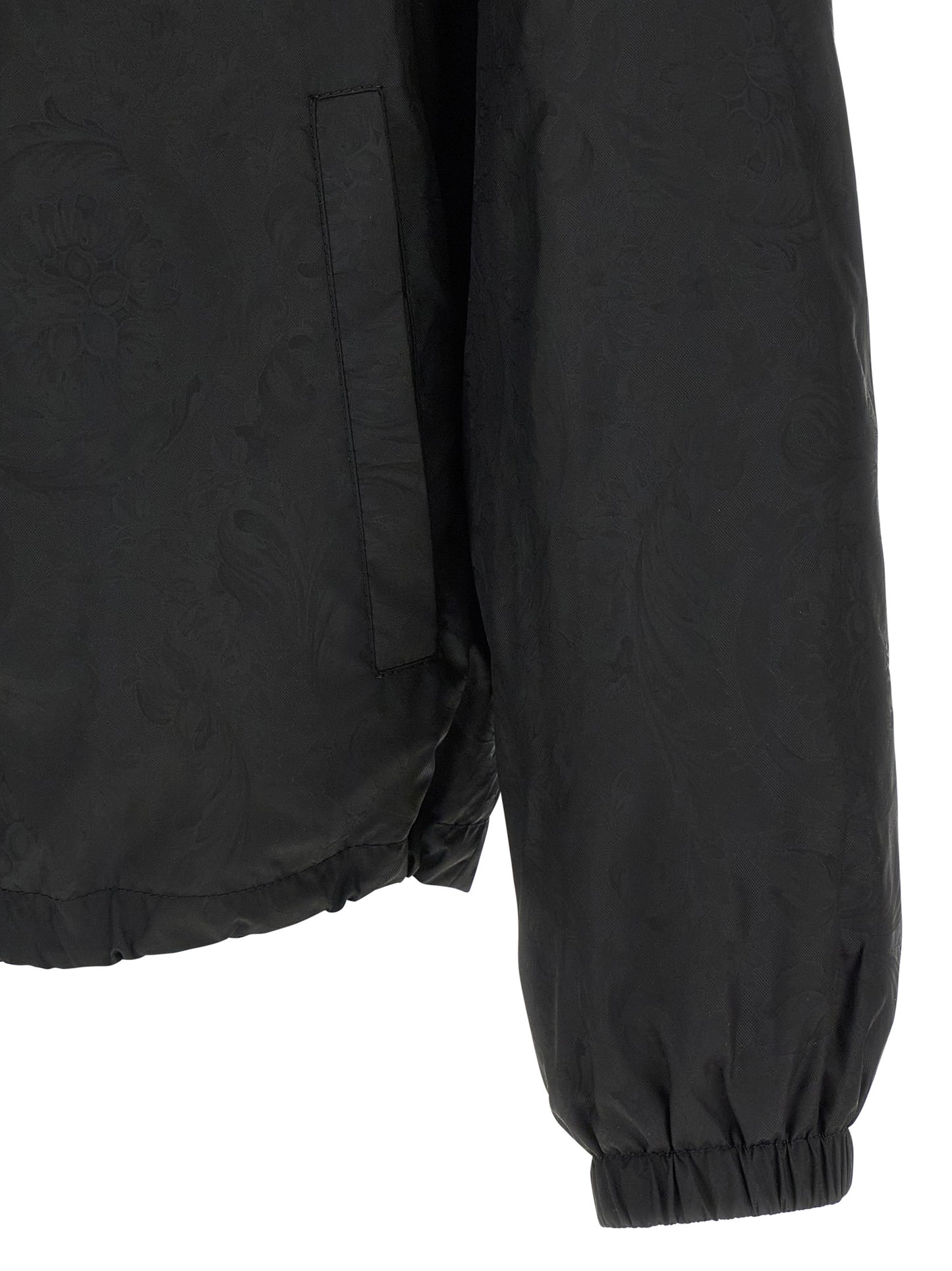 Hooded Windbreaker Jacket by Versace for men in nylon black, patterned & jacquard features an enduring silhouette, showcasing technical hooded & windproof and a sophisticated for a truly enduring aesthetic.