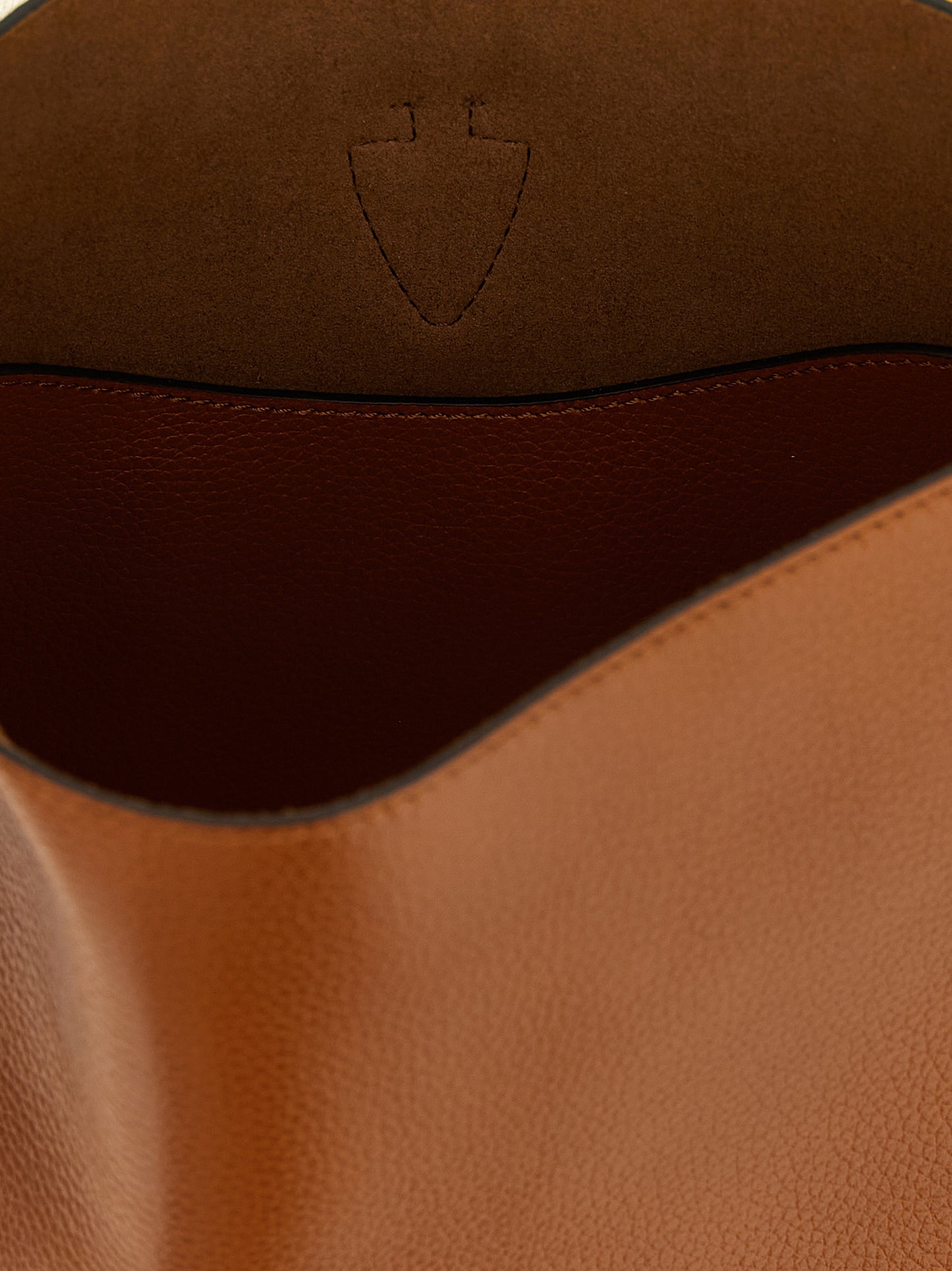 This Large Crossbody Bucket Handbag by Tod's for women in calfskin leather and brown presents a sculptural silhouette featuring a secure snap & button, ample , and versatile crossbody-strap, shoulder-strap, adjustable-strap & handle for a sculptural finish.