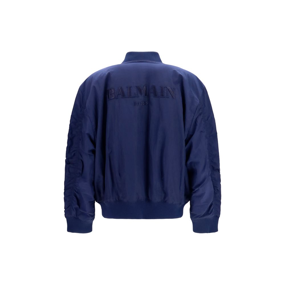 Bomber Jacket by Balmain for men in nylon blue features a dramatic silhouette, showcasing a sophisticated and distinctive pockets for a dramatic aesthetic.