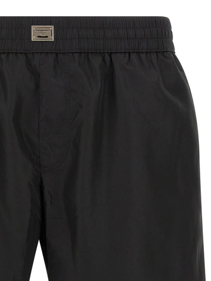 Swim Shorts by Dolce & Gabbana for men in stretch nylon black showcases a contemporary silhouette, artfully capturing the essence of the contemporary Men's Stretch Nylon Swim Shorts design for a sophisticated look.