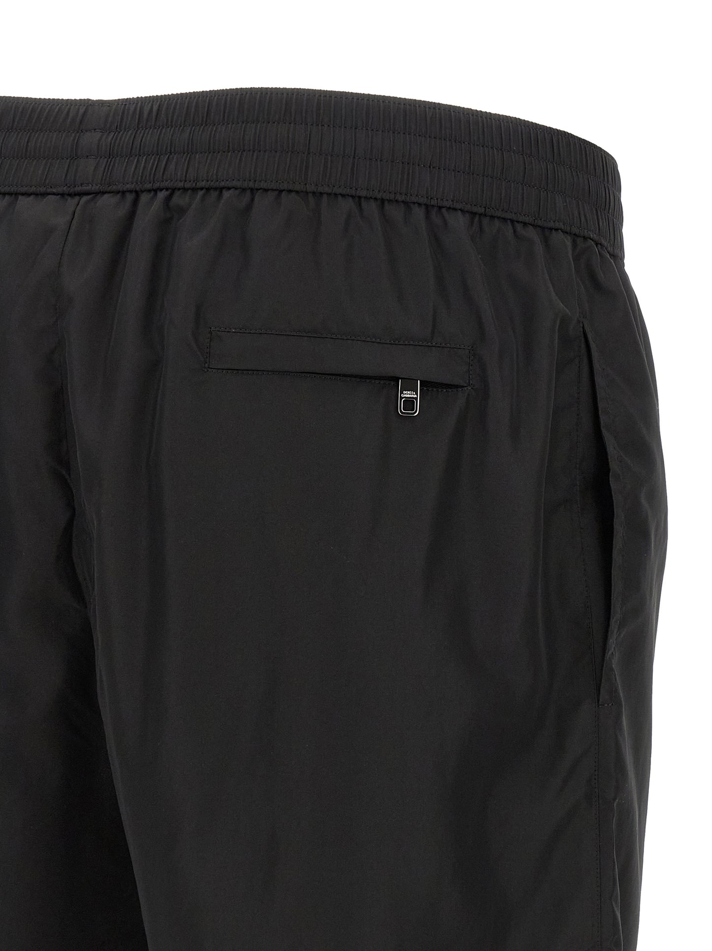 Swim Shorts from Dolce & Gabbana for men in stretch nylon black features an sleek silhouette, showcasing the distinct style of the Men's Stretch Nylon Swim Shorts collection.