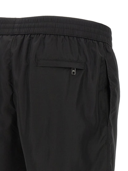 Swim Shorts from Dolce & Gabbana for men in stretch nylon black features an sleek silhouette, showcasing the distinct style of the Men's Stretch Nylon Swim Shorts collection.