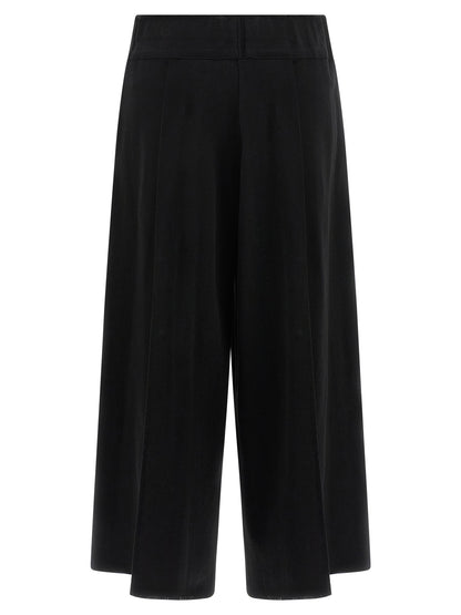 Casual Pants by Issey Miyake for women in polyurethane & nylon black features a polished silhouette with a polished wide, reaching a polished long and finished with a polished .