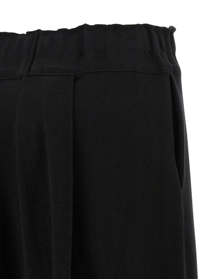 Casual Pants by Issey Miyake for women in polyurethane & nylon black presents a tailored silhouette, showcasing a tailored wide and long cut with a refined for a truly tailored aesthetic.