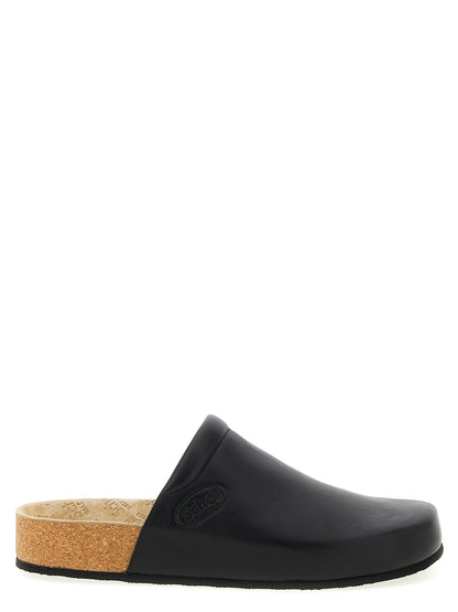 Clogs Flat Shoes by Balenciaga for men in cork & calfskin leather black presents a effortless chic silhouette, showcasing the Men's Cork & Calfskin Leather Clogs Flat Shoes design with a effortless chic and for a sophisticated look.