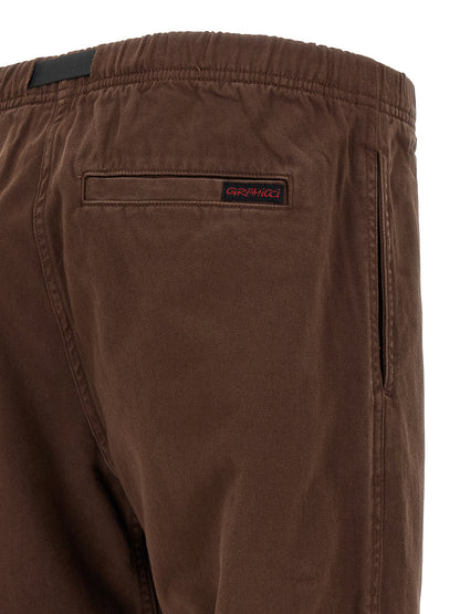 Trousers by Gramicci for men in organic cotton twill brown features a sculptural silhouette, showcasing a sculptural wide and long with a sophisticated for a sculptural finish.
