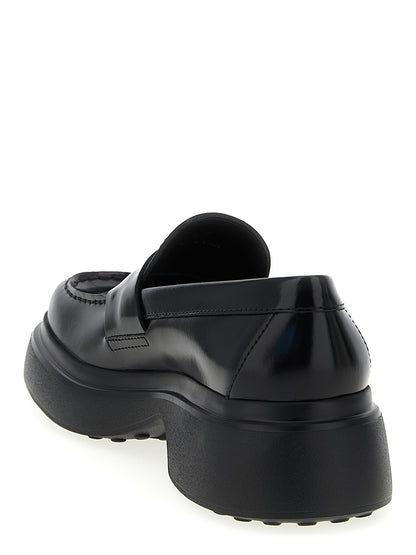 Flat Loafer Slip-On Shoes by Tod's for women in calfskin leather black showcases a impeccable silhouette as Women's Calfskin Leather Flat Loafer Slip-On Shoes, artfully designed with a impeccable flat and refined for a impeccable finish.