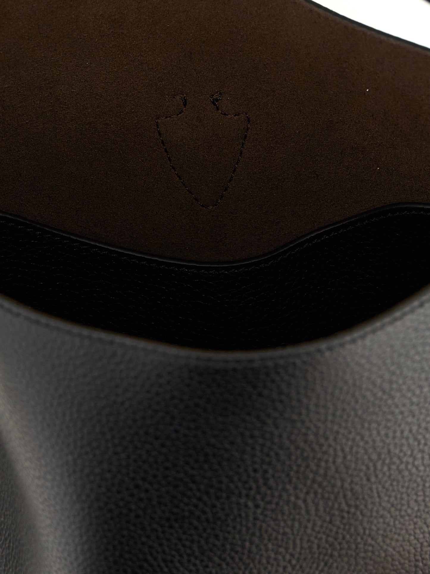 This Mini Bucket Handbag by Tod's for women in calfskin leather and black presents a sculptural silhouette featuring a secure snap & button, ample , and versatile shoulder-strap, handle & adjustable-strap for a sculptural finish.