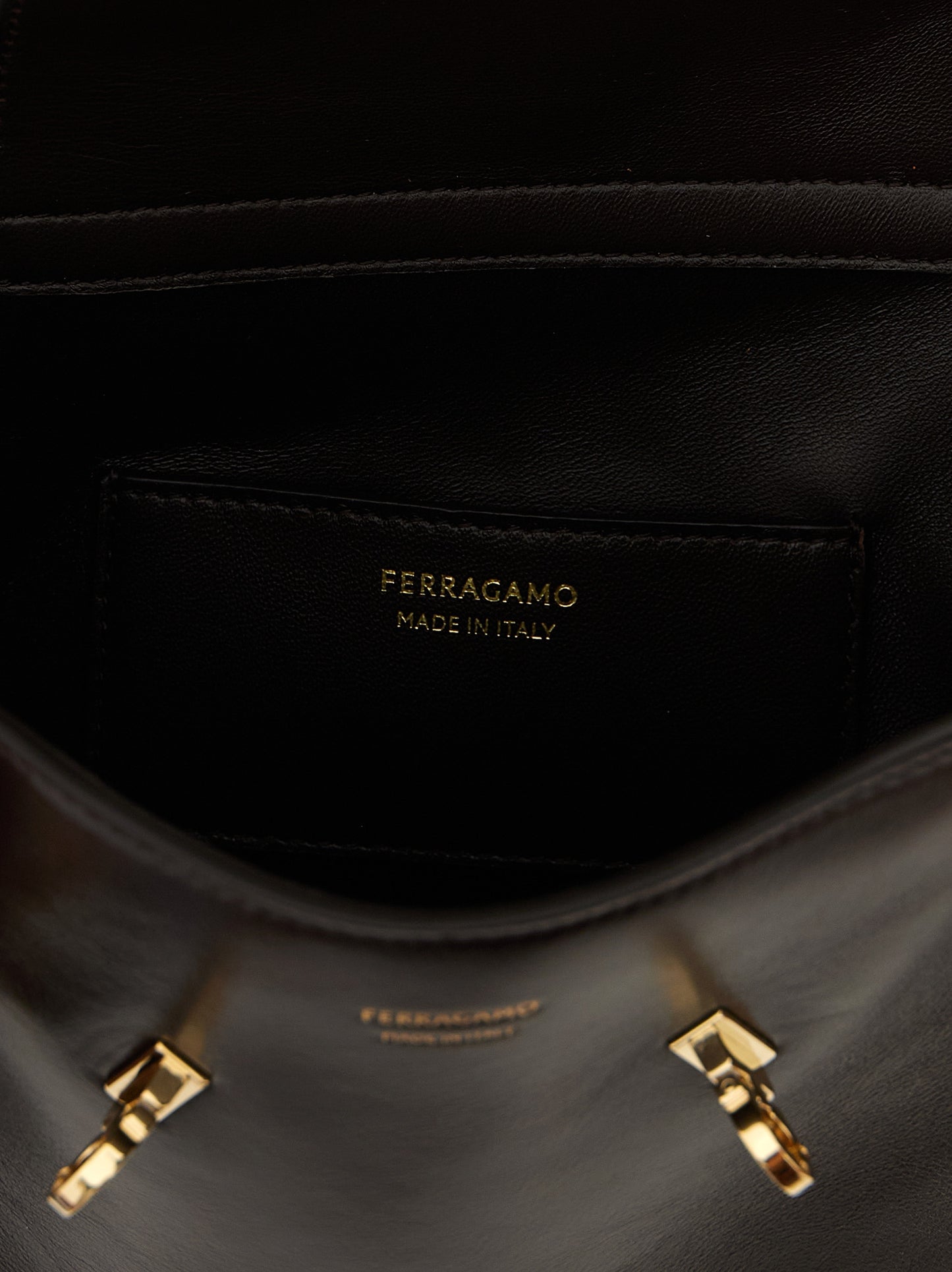 Crossbody Fanny Pack Handbag by Ferragamo for women in bos taurus suede calf leather brown features a versatile chic silhouette, meticulously detailed with a secure flap, magnetic & buckle, ample , and versatile crossbody-strap, shoulder-strap & belt-strap.