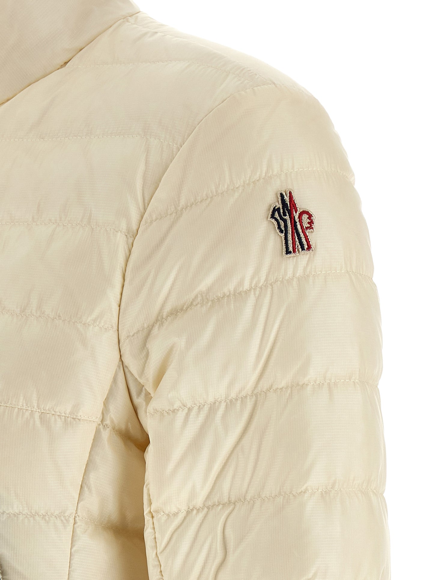 Puffer Jacket by Moncler Grenoble for women in polyamide & goose-down white & signature features a dramatic silhouette, showcasing a sophisticated and distinctive insulated for a dramatic aesthetic.
