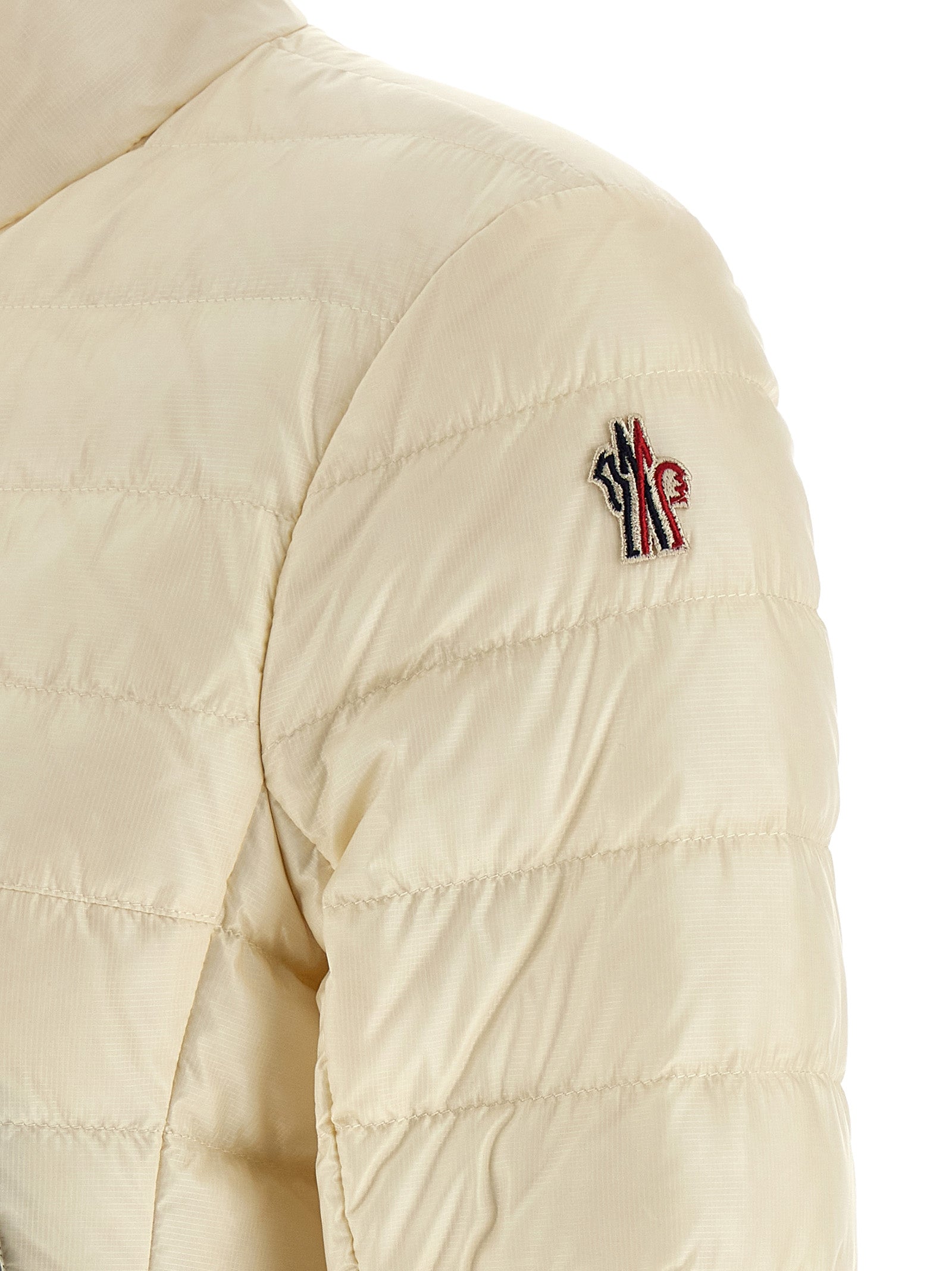 Puffer Jacket by Moncler Grenoble for women in polyamide & goose-down white & signature features a dramatic silhouette, showcasing a sophisticated and distinctive insulated for a dramatic aesthetic.