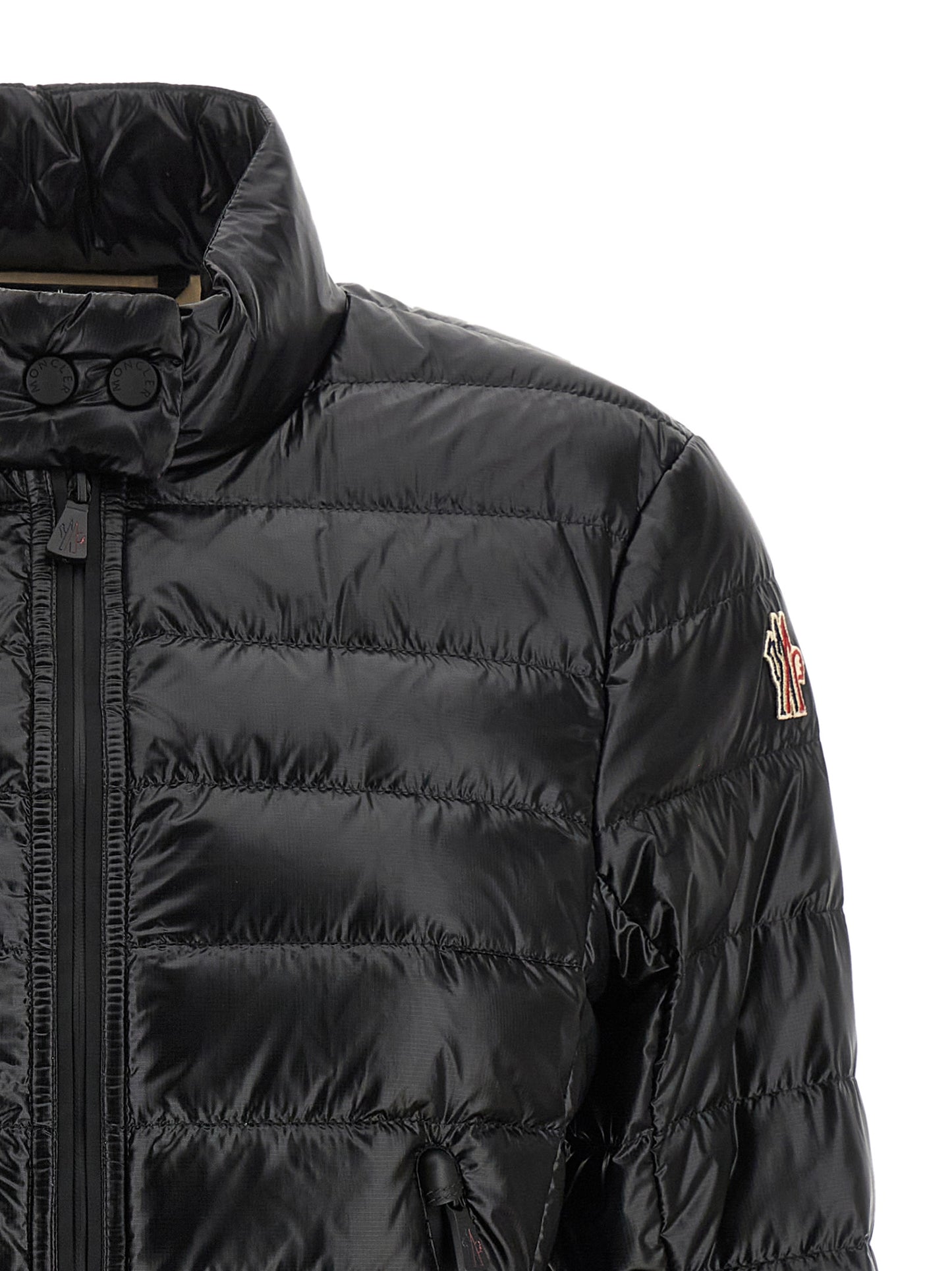 Puffer Jacket by Moncler Grenoble for women in nylon & goose-down black & signature showcases a bohemian silhouette, artfully detailed with a bohemian high-neck neckline and signature insulated for a truly bohemian finish.