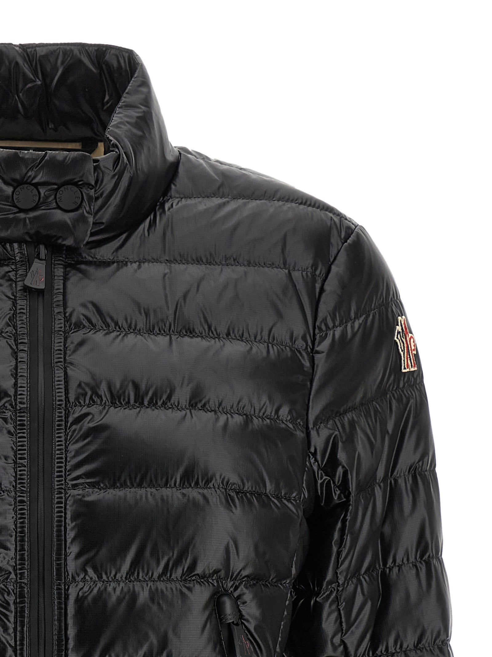Puffer Jacket by Moncler Grenoble for women in nylon & goose-down black & signature showcases a bohemian silhouette, artfully detailed with a bohemian high-neck neckline and signature insulated for a truly bohemian finish.