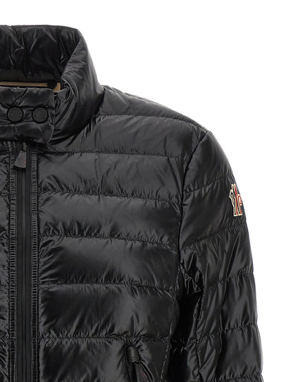 Puffer Jacket by Moncler Grenoble for women in nylon & goose-down black & signature showcases a bohemian silhouette, artfully detailed with a bohemian high-neck neckline and signature insulated for a truly bohemian finish.