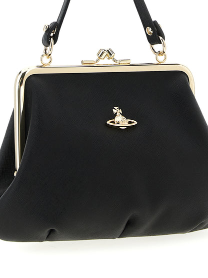 This Frame Handbag by Vivienne Westwood for women in cotton & saffiano leather and black presents a sculptural silhouette featuring a secure snap, ample , and versatile shoulder-strap, handle & detachable-strap for a sculptural finish.