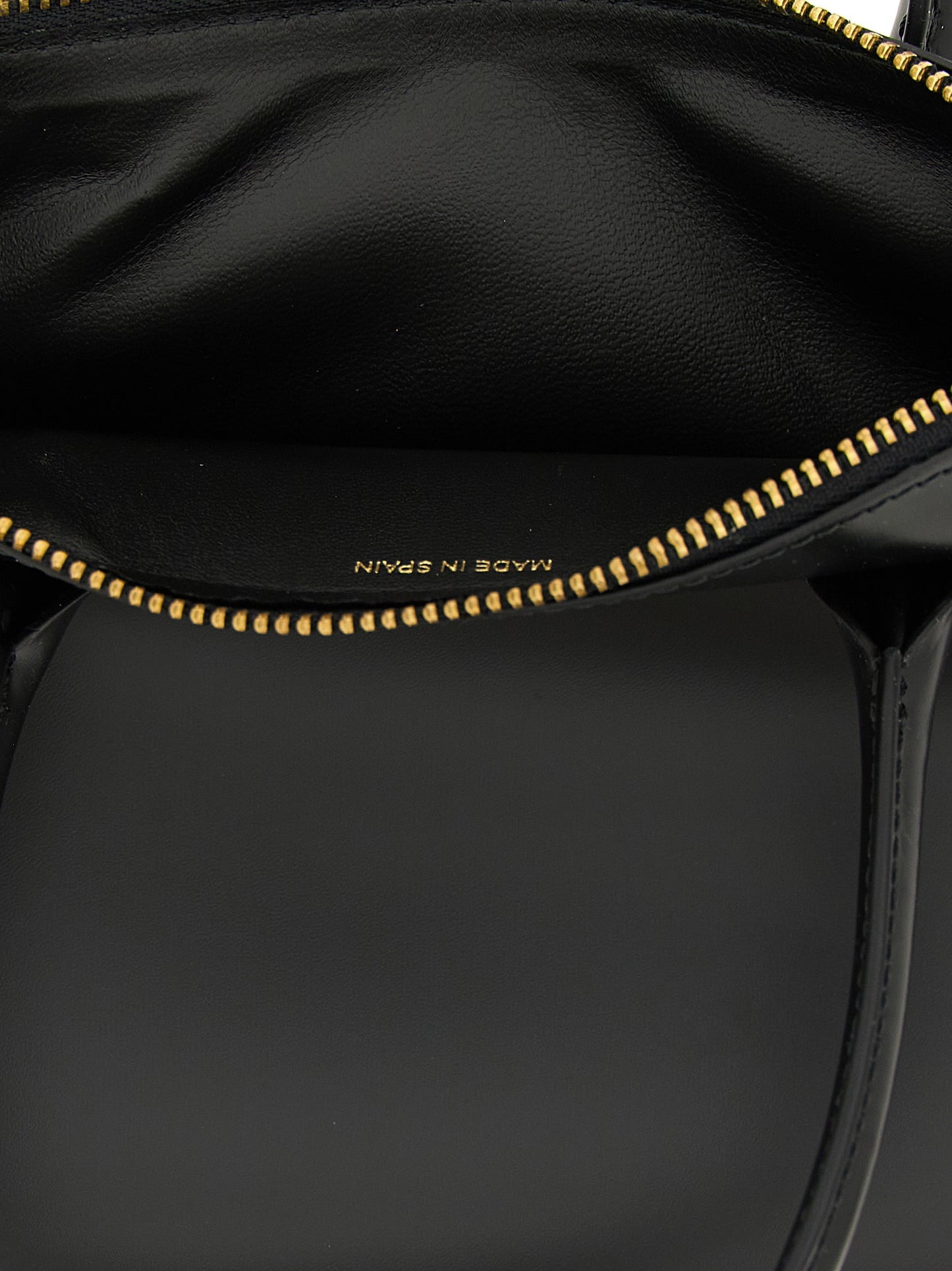 Handbag by Comme Des Garçons for unisex in leather black features a signature silhouette, showcasing a secure zipper and signature with versatile handle for a sophisticated look.