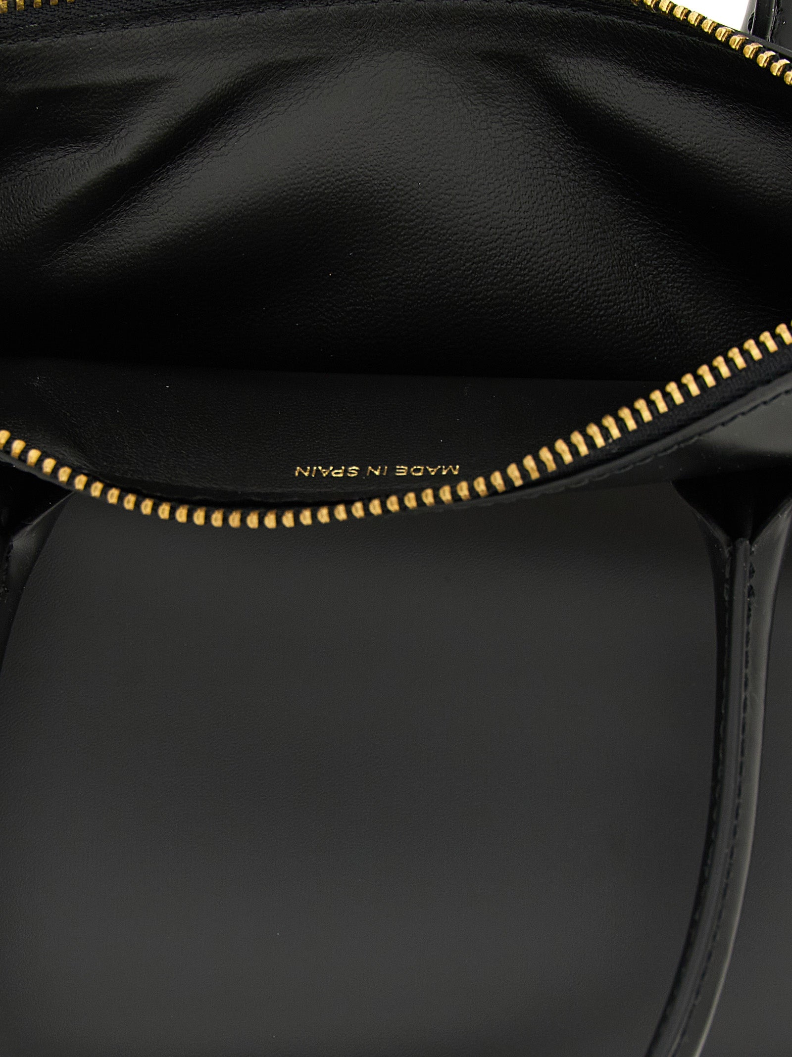 Handbag by Comme Des Garçons for unisex in leather black features a signature silhouette, showcasing a secure zipper and signature with versatile handle for a sophisticated look.
