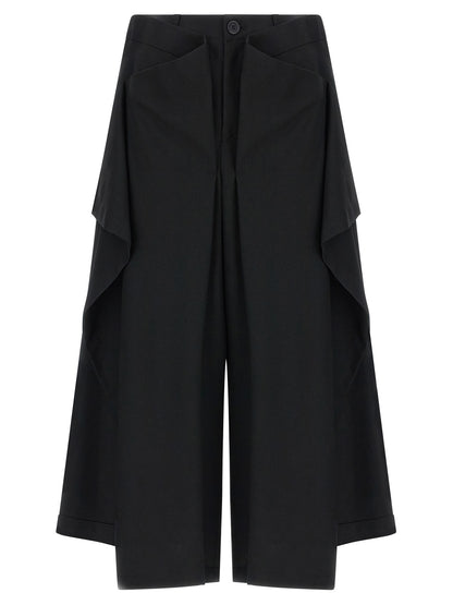 Trousers by Issey Miyake for women in wool black & signature features an sartorial silhouette, showcasing a precise wide and long with a sartorial for a refined look.