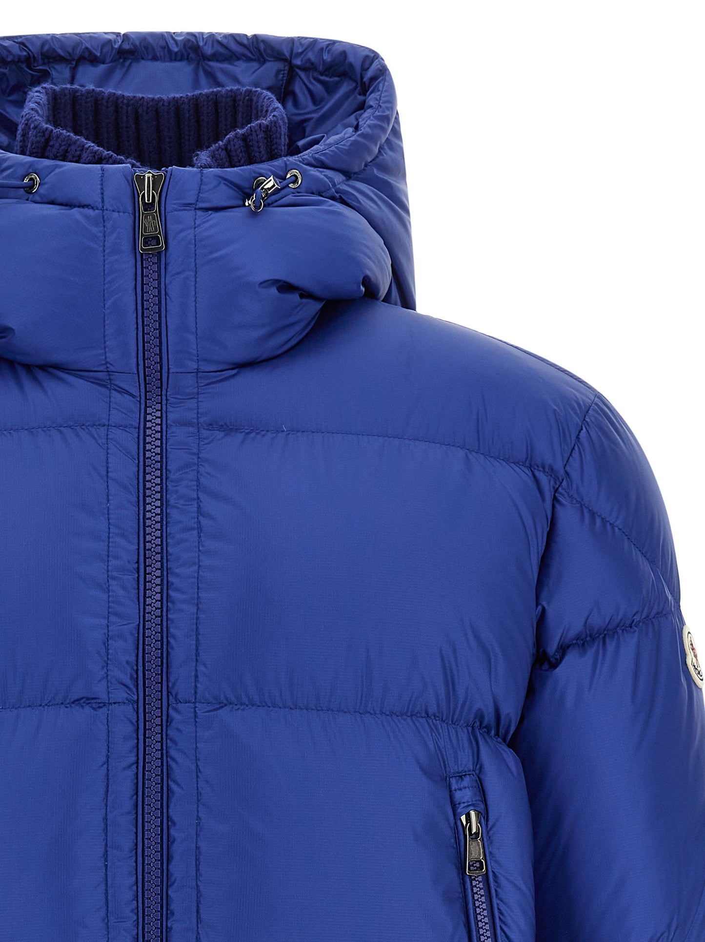 This Hooded Puffer Jacket by Moncler for men in polyamide wool & goose-down blue & signature exhibits a edgy silhouette, meticulously detailed with functional hooded & insulated and a edgy hooded high-neck neckline for a edgy finish.