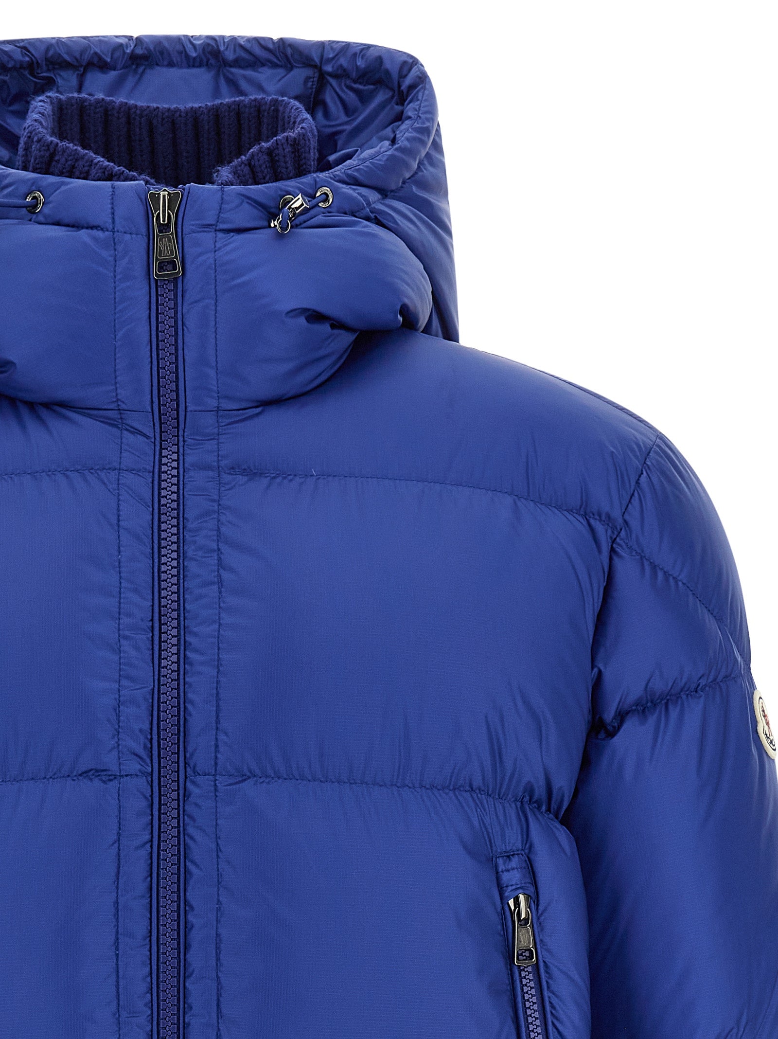This Hooded Puffer Jacket by Moncler for men in polyamide wool & goose-down blue & signature exhibits a edgy silhouette, meticulously detailed with functional hooded & insulated and a edgy hooded high-neck neckline for a edgy finish.