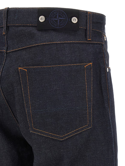 Jeans by Stone Island for men in organic cotton denim blue, indigo & signature features a polished silhouette with a polished straight-leg, reaching a polished long and finished with a polished .