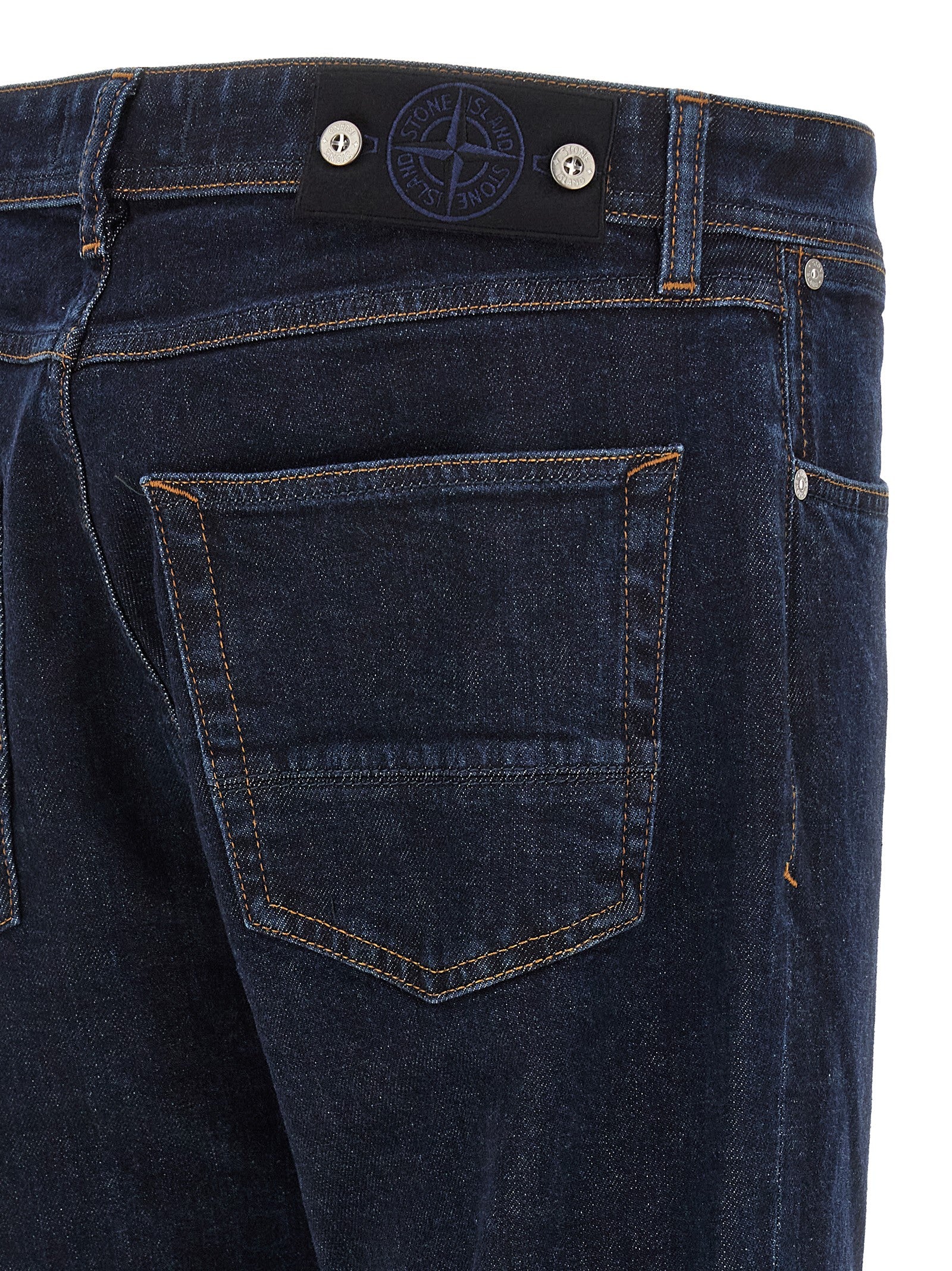Jeans by Stone Island for men in stretch organic cotton denim blue, indigo & signature presents a tailored silhouette, showcasing a tailored straight-leg and long cut with a refined for a truly tailored aesthetic.