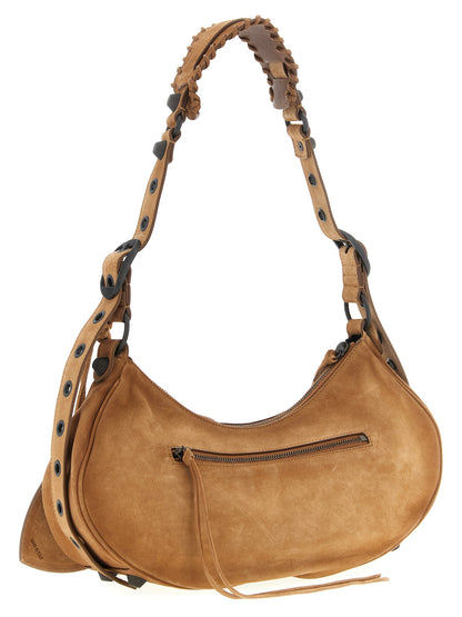 Shoulder Crescent Bag by Balenciaga for women in zamak brass canvas & suede calf leather brown features a distinguished silhouette, showcasing a secure zipper and distinguished with versatile shoulder-strap, adjustable-strap & handle for a distinguished finish.