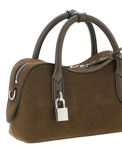 This Handbag by Stella McCartney for women in polyester and brown presents a sculptural silhouette featuring a secure zipper, ample , and versatile shoulder-strap, adjustable-strap & handle for a sculptural finish.