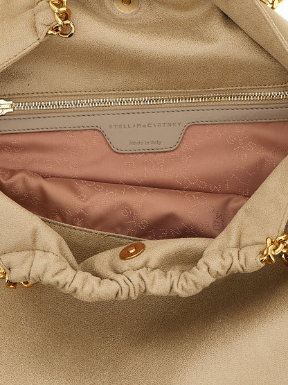 Shoulder Drawstring Bag by Stella McCartney for women in polyester beige, gold & signature showcases a statuesque silhouette, artfully detailed with a secure drawstring & magnetic, organized , and versatile shoulder-strap & handle for a statuesque look.