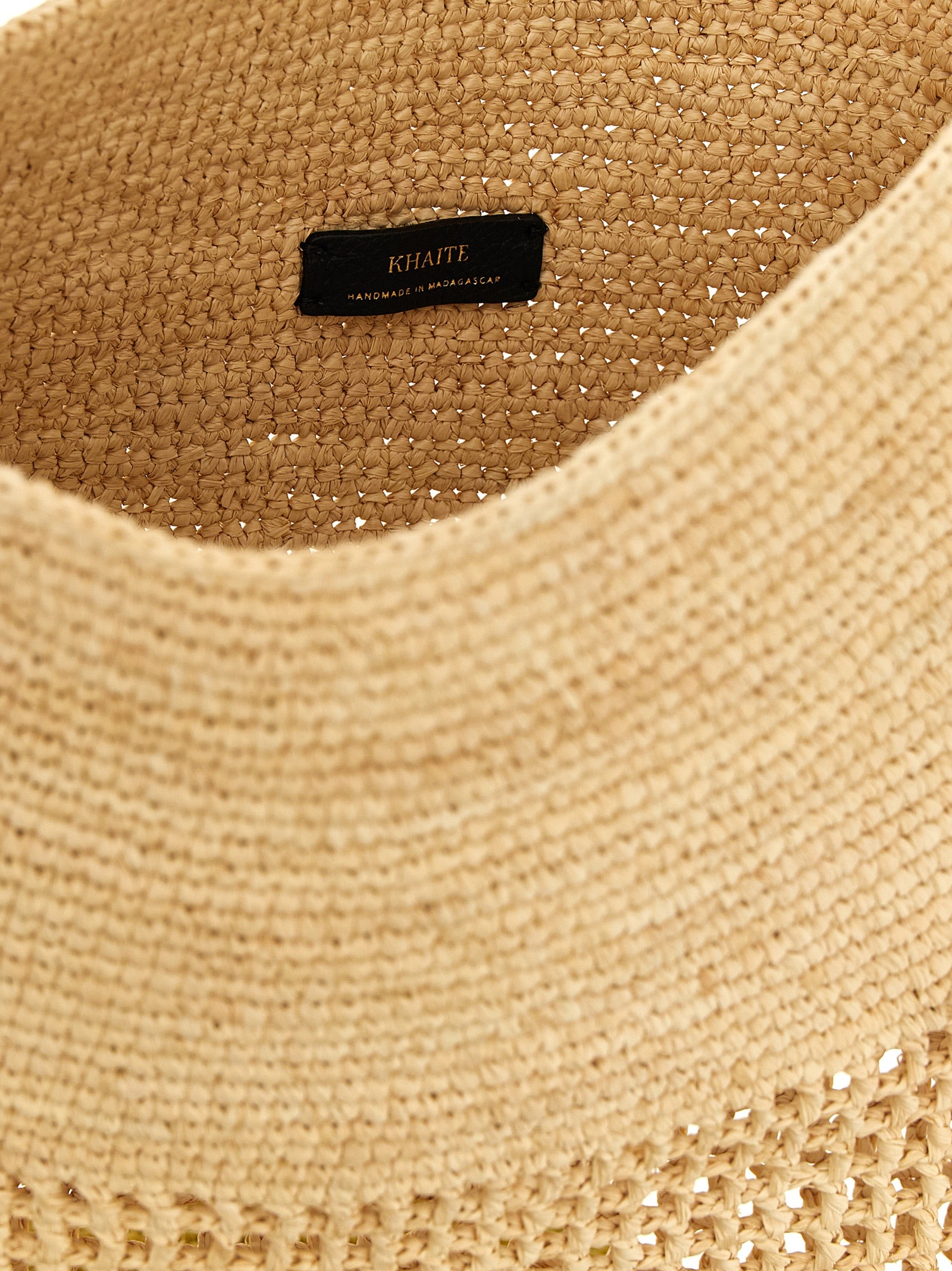 Small Shoulder Bucket Bag by Khaite for women in raffia palm fiber & calfskin beige & natural presents a versatile silhouette, showcasing a secure and versatile with versatile shoulder-strap & adjustable-strap for a sophisticated look.