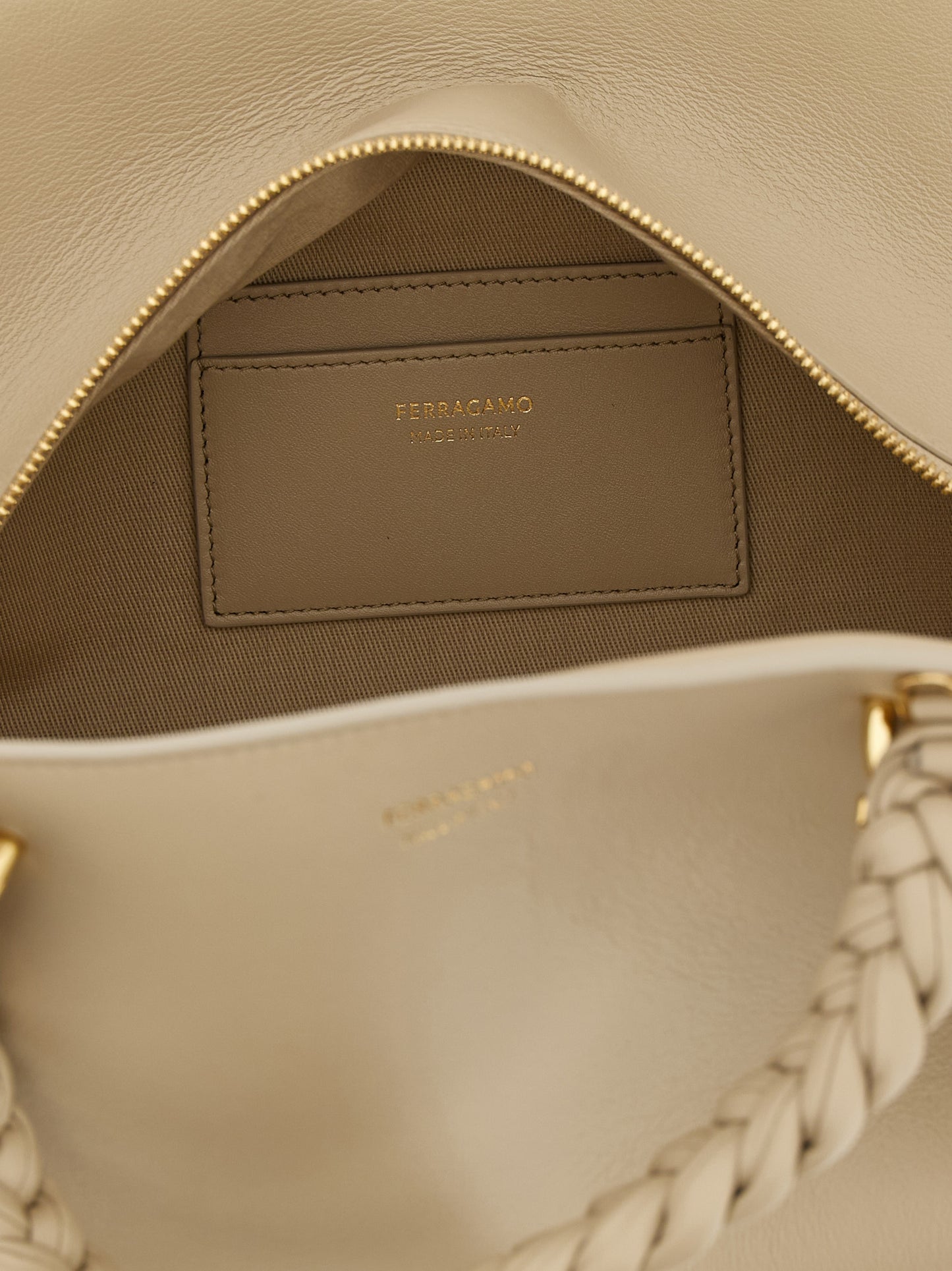 Handbag by Ferragamo for women in calfskin leather gray features an refined silhouette, showcasing a secure zipper, ample , and versatile shoulder-strap, adjustable-strap & handle for a sophisticated refined aesthetic.
