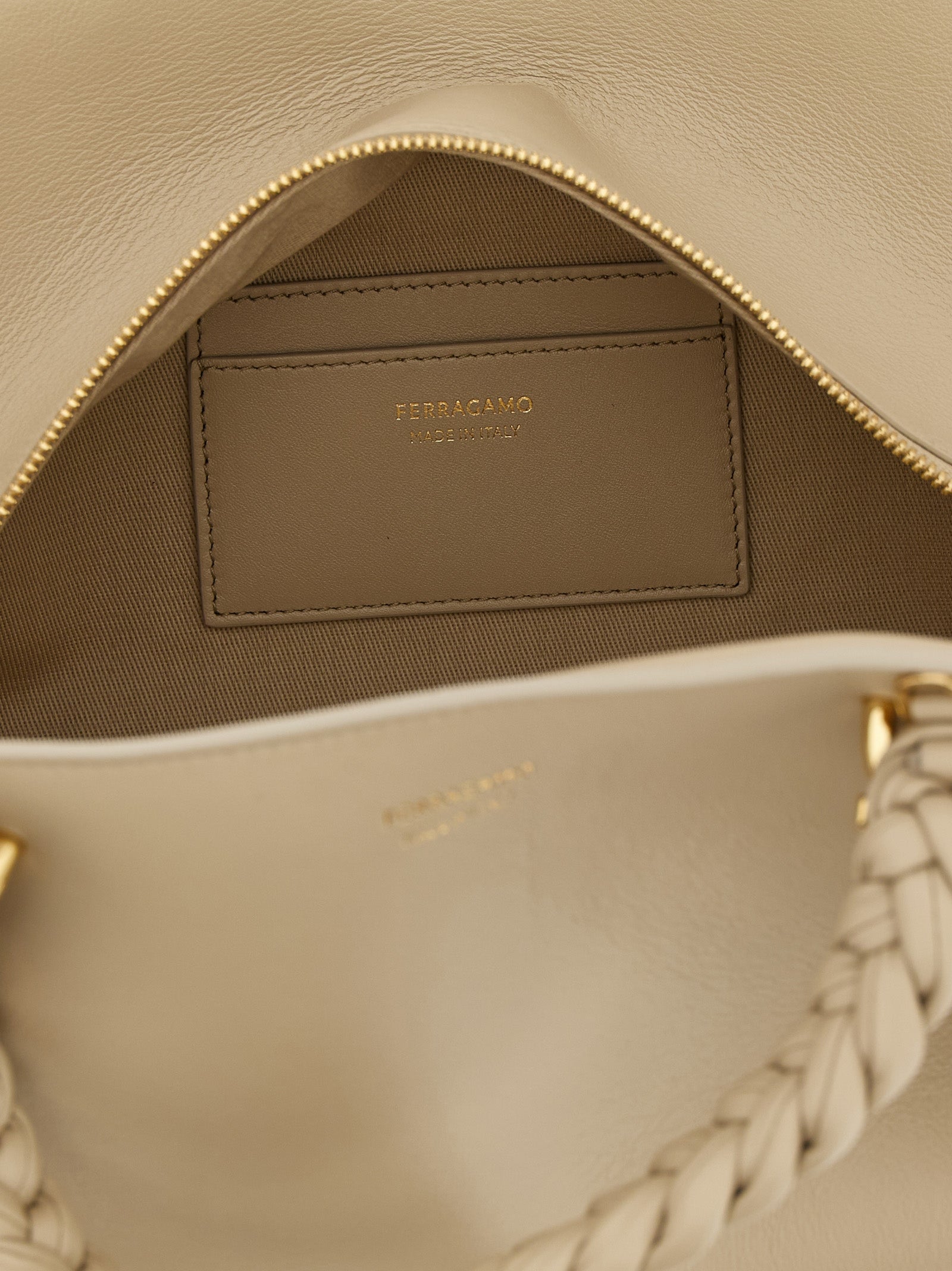 Handbag by Ferragamo for women in calfskin leather gray features an refined silhouette, showcasing a secure zipper, ample , and versatile shoulder-strap, adjustable-strap & handle for a sophisticated refined aesthetic.