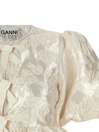 Blouse by Ganni for women in polyamide polyester satin white & jacquard showcases a sharp silhouette, elegantly detailed with a sharp crew neckline and sharp .