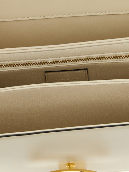 2-in-1 Shoulder & Crossbody Flap Bag by Gucci for women in calfskin leather white features an effortlessly chic silhouette with a secure flap, ample , and versatile crossbody-strap, shoulder-strap & adjustable-strap for effortlessly chic everyday luxury.