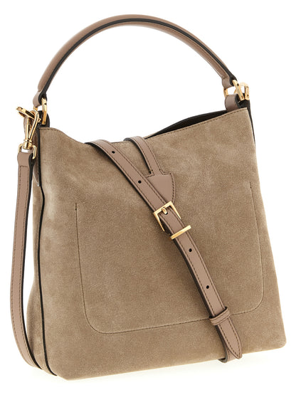 This Mini Bucket Handbag by Tod's for women in calfskin leather and beige presents a sculptural silhouette featuring a secure snap, ample , and versatile shoulder-strap, adjustable-strap & handle for a sculptural finish.
