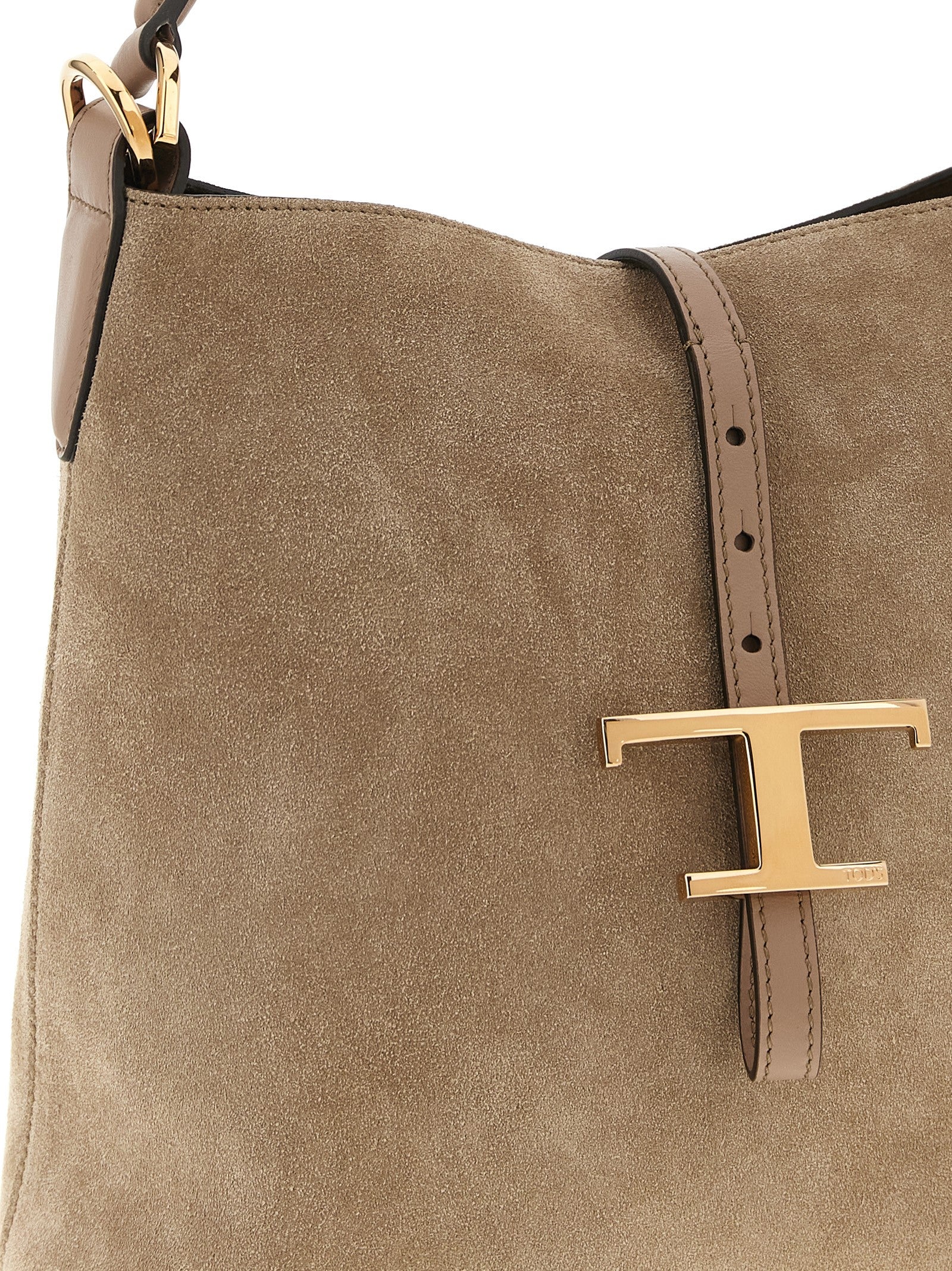 Mini Bucket Handbag by Tod's for women in calfskin leather beige features an refined silhouette, showcasing a secure snap, ample , and versatile shoulder-strap, adjustable-strap & handle for a sophisticated refined aesthetic.
