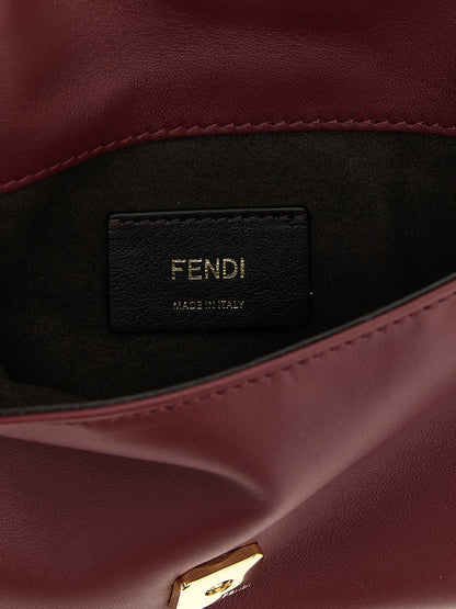 Shoulder Baguette Clutch Handbag by Fendi for women in lamb leather bordeaux & signature showcases a sculptural silhouette, featuring a secure flap & magnetic, ample , and versatile shoulder-strap & wristlet for a sculptural aesthetic.