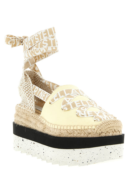 Wedge Sandals by Stella McCartney for women in raffia viscose canvas & faux leather bicolour & yellow presents a sculptural silhouette, showcasing the Women's Raffia Viscose Canvas & Faux Leather Wedge Sandals design with a sculptural wedge and for a premium look.