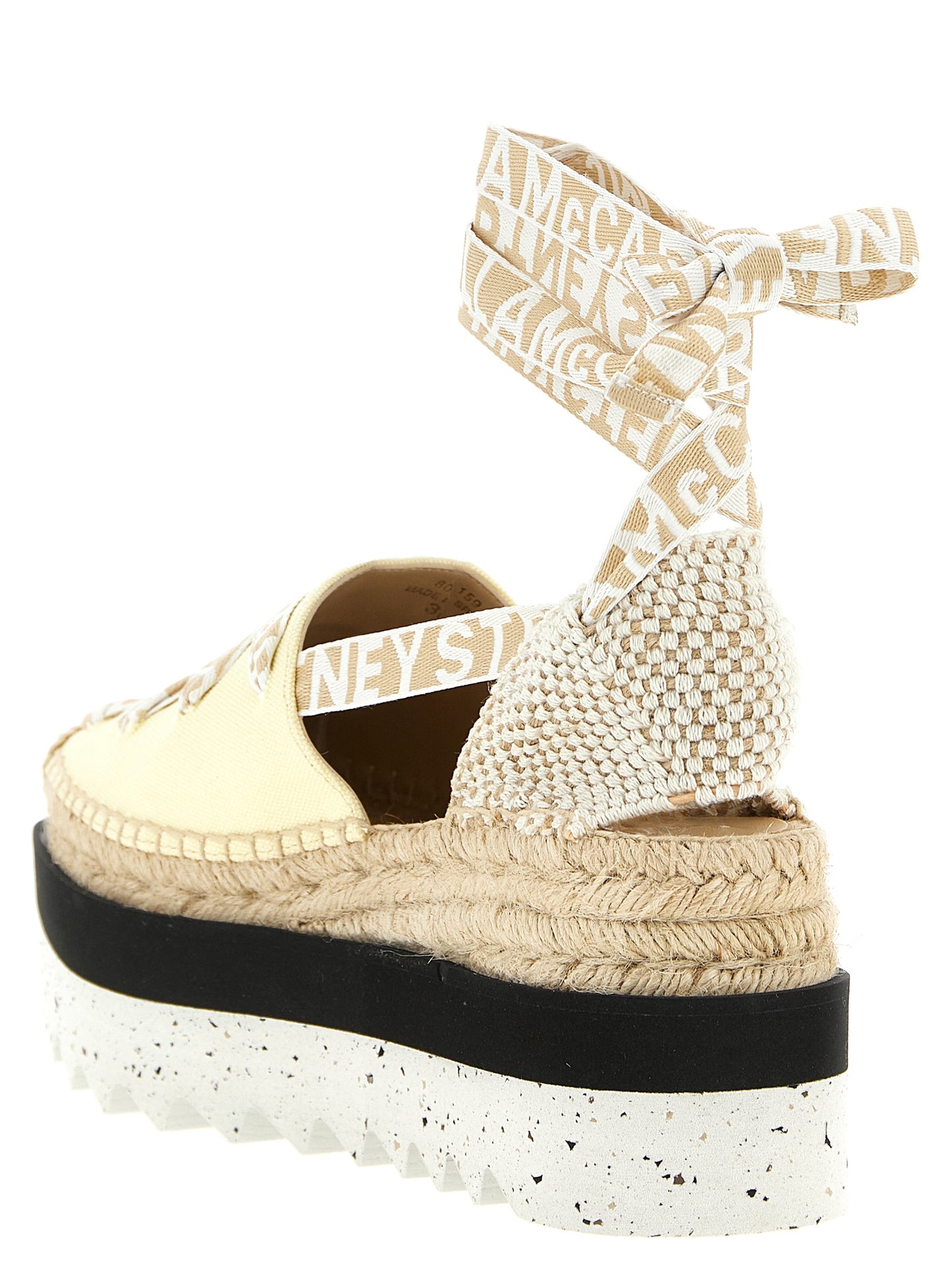 Wedge Sandals by Stella McCartney for women in raffia viscose canvas & faux leather bicolour & yellow features an effortlessly chic silhouette from the Women's Raffia Viscose Canvas & Faux Leather Wedge Sandals collection, showcasing a effortlessly chic wedge and elegant .