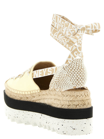 Wedge Sandals by Stella McCartney for women in raffia viscose canvas & faux leather bicolour & yellow features an effortlessly chic silhouette from the Women's Raffia Viscose Canvas & Faux Leather Wedge Sandals collection, showcasing a effortlessly chic wedge and elegant .